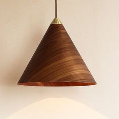 a wooden light fixture hanging from a ceiling