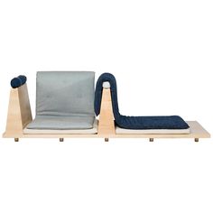 two chairs sitting next to each other on top of a wooden stand with blue and grey cushions