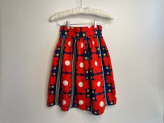 "Absolutely adorable! Here we have a 60s vintage MOD skirt in red, blue, yellow and white bold floral print.  Fitted at the waist and flared. Skirt is gathered at the waistband with large pleats -- secured using two snaps. Metal zipper located in the back.  Dimensions:  Length: 21.5: Waist: 25\" Condition:  Excellent. No visible stains, rips, runs or tears." Vintage Retro Print Skirt For Spring, Vintage Skirt With Retro Print For Spring, Retro Skirt With Retro Print For Spring, Retro Red Summer Skirt, Retro Spring Pleated Skirt, Retro Pleated Skirt For Spring, Retro Spring Pencil Skirt, Retro Red Skirt For Spring, Fitted Skirt With Retro Print For Spring