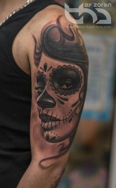 a man with a skull tattoo on his arm