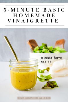 a jar filled with mustard and lettuce on top of a white counter next to a