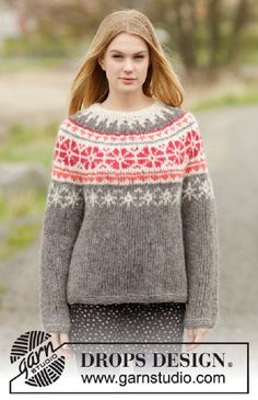 a woman is walking down the street wearing a sweater