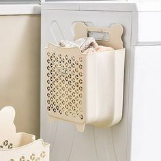 a laundry basket hanging on the side of a washing machine