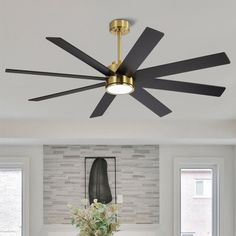 a living room with a couch, coffee table and ceiling fan in the middle of it