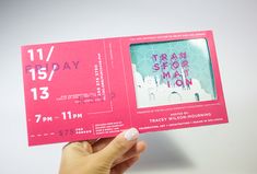 a person holding up a pink ticket for an event