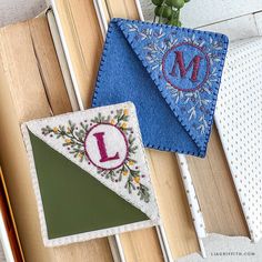 two pieces of fabric with the letter l on them are sitting next to each other