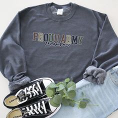 Show your unwavering support with our "Proud Army Mom" sweatshirt! This shirt proudly features the message in a combination of collegiate and script fonts, set against a color palette inspired by the Army, and boldly outlined in soft white. Product Details Ideal for any situation, a unisex heavy blend crewneck sweatshirt is pure comfort. These garments are made from polyester and cotton. This combination helps designs come out looking fresh and beautiful. The collar is ribbed knit, so it retains its shape even after washing. There are no itchy side seams on these sweaters. >50% cotton, 50% polyester >Medium-heavy fabric (8.0 oz/yd² (271.25 g/m²)) >Loose fit >Sewn-in label >Runs true to size Care Instructions Machine wash: cold (max 30C or 90F); Non-chlorine: bleach as needed; Tumble dry: l Cotton Team Spirit Sweatshirt With Lettering, Collegiate Cotton Sweats With Letter Print, Collegiate Cotton Sweatshirt With Lettering, Cotton College Sweats With Letter Print, Varsity Cotton Sweatshirt With Text Print, Relaxed Fit Text Print Sweatshirt For School Spirit, Relaxed Fit Sweatshirt With Text Print For School Spirit, Relaxed Fit School Spirit Sweatshirt With Text Print, Cotton Fan Apparel Sweatshirt With Text Print