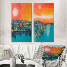 two paintings are hanging on the wall above a couch in a living room with white furniture