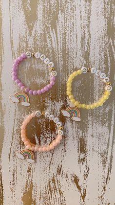 "Every girl needs a Rainbow 🌈 in her life! This bracelet is perfect for anyone any occasion! All orders come with 1 custom name bracelet (your choice from 7 color beads) and a rainbow charm. 💝Add an extra charm or 2 to any of your bracelets for a low price of $1 each 👉🏻 https://etsy.me/36LE9om 🔺All our bracelets are handmade with quality stretchy strings. In order to keep the string from breaking, we used a double string method to make our bracelets. However, It does give you a tighter feel Fun Custom Name Jewelry With Round Beads, Fun Custom Name Round Beads Jewelry, Personalized Yellow Beaded Bracelets, Personalized Yellow Beaded Bracelets With Round Beads, Customizable Beaded Bracelets As Gift, Playful Beaded Name Bracelet For Birthday, Personalized Playful Beaded Bracelets, Cute Beaded Name Bracelet As Personalized Gift, Playful Beaded Name Bracelet As Gift