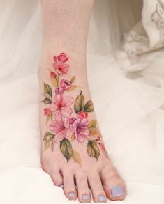 a woman's foot with flowers painted on it