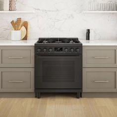 a stove top oven sitting inside of a kitchen next to counter tops and shelves with utensils