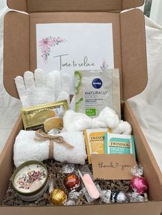 a box filled with white towels and other items for a spa day or bridal party