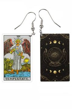 two taroti cards are hanging from earrings