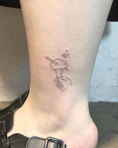 a small tattoo on the ankle of a woman