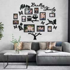 a living room with a couch, coffee table and family tree wall decal on the wall