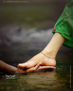 a woman's bare foot in the water with her hand on top of it