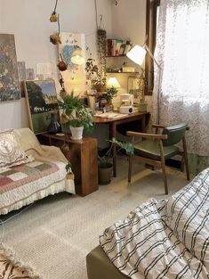 a bedroom with a bed, desk and chair in it's center area next to a window