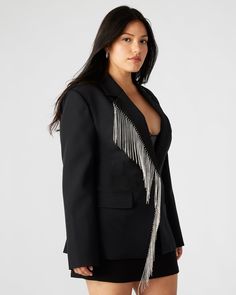 The NELLIE blazer is a stunning, single-breasted blazer that features rhinestone fringe detailing and functional flap pockets. Designed with a back vent and faux chest welt pockets, this blazer offers a touch of glamour and sophistication to any outfit. Perfect for work or special occasions. Rhinestone fringe blazer Single-breasted Two functional front pockets Length: 28.5" 97% polyester 3% elastane Hand wash Amelia is 5ft 10.5in and is wearing a size small Vanessa is 5ft 8in and is wearing a si Embellished Blazer With Notch Lapel For Work, Embellished Notch Lapel Blazer For Work, Fall Embellished Outerwear With Notch Lapel, Chic Embellished Blazer For Fall, Tailored Embellished Blazer For Office, Chic Embellished Office Blazer, Glamorous Tailored Outerwear With Notch Lapel, Chic Embellished Blazer For Workwear, Chic Notch Lapel Embellished Blazer