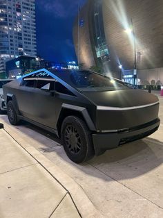 a futuristic car parked in front of a building at night