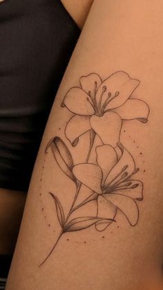 a woman's thigh with a flower tattoo on it