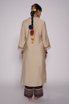 Ivory chanderi kurta with zardozi embroidered yoke. Comes with chanderi purple pant with embroidered hem and purple organza dupatta.
Component: 3
Pattern: Embroidered
Type Of Work: Zardozi Floral Motifs
Neckline: V-Neck
Sleeve Type: Three Quarter
Fabric: Kurta and Pant: Chanderi, Dupatta: Organza
Color: Ivory
Other Details: 
Lined kurta
Embroidered pant hem
Sequin and gota floral pattern on dupatta
Embroidered dupatta hem with fringed lace
Occasion: Puja - Aza Fashions Chanderi Dupatta, Kurta Pant Set, Embroidered Hem, Embroidered Pants, Purple Pants, Embroidered Dupatta, Organza Dupatta, Kurta With Pants, Pajama Set Women