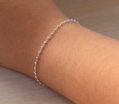 Sterling Silver Bracelet, Simple Thin Silver Bracelet on Delicate chain, Dainty Satellite Bracelet with Rondelle Beads I've made this dainty minimalist bracelet with tiny Sterling Silver rondelle beads fixed on delicate yet strong Sterling Silver chain to add a delicate touch to your look. Ideal present for the ones you love if you beat the temptation to keep it for yourself. ⭐️ DETAILS Sterling Silver chain accented with rondelle beads 2 mm Sterling Silver spring ring closure Comes in a Gift Bo Simple White Gold Bracelet, Cute Silver Bracelets Simple, Simple Silver Accessories, Silver Dainty Bracelet, Silver Women Bracelet, Acotar Accessories, Cute Bracelets Silver, Silver Bracelet For Women Simple, Cute Silver Bracelets