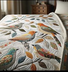 a quilted bed with birds on it and leaves in the middle, along with two nightstands