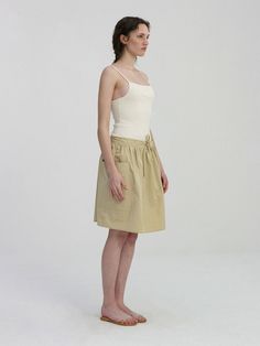 Editor's NoteThis is a flared knee-length skirt. A relaxed A-line silhouette is created with abundant shirring details along the waist line.- Added practicality with big out pocket structure on both sides- Waist banding and drawstring fastening structure make it easy to adjust the size and provide a comfortable fit- Solid and light weight with cotton and nylon twill blend*Please refer to the detail cut for product color, and it may differ from the actual color depending on the monitor resolution.Measurements (in.)ONE SIZE (XS-M)- Width: 30.31 in.- Waist: 16.14 in.- Hip: 23.23 in.- Length: 20.47 in.*Model size: Height 5'71, Bust 31.5, Waist 23.5, Hips 34*The detailed size is based on cross-section, and there may be a 0.39-0.79 inch error depending on the measurement method.Composition & Relaxed Cargo Skirt With Elastic Waistband For Summer, Summer Cargo Skirt With Elastic Waistband And Relaxed Fit, Summer Cargo Skirt With Elastic Waistband, Short Length Relaxed Cargo Skirt For Spring, Knee-length Skirt With Gathered Waist, Daywear Beige Flared Skirt, Beige Flared Skirt For Daywear, Chic Relaxed Cargo Skirt For Summer, Beige Knee-length Skirt With Pockets