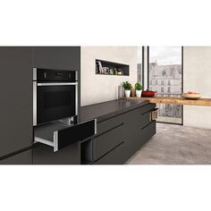 an image of a kitchen setting with black cabinets