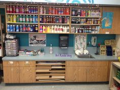 a counter with lots of bottles and other items on it in a room that is filled with children's toys