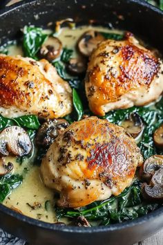 chicken with mushrooms and spinach in a skillet