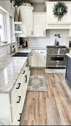 a kitchen with white cabinets and wood floors is featured in the instagramm post