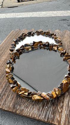 a mirror sitting on top of a wooden table