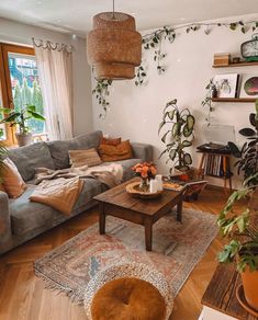 a living room filled with furniture and lots of plants