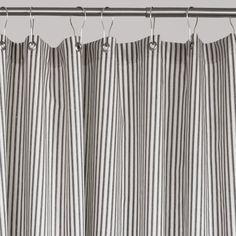 black and white striped curtains hanging on a metal rod