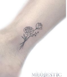 a small rose tattoo on the ankle is shown in black and grey ink, with tiny leaves