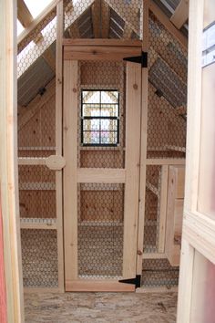 the inside of a chicken coop with two doors and windows on each side of the door