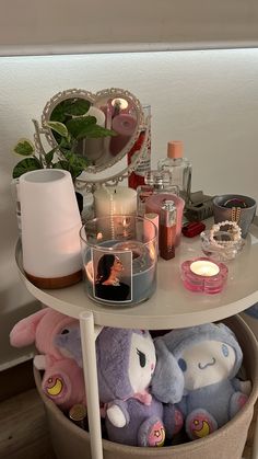 a white table topped with lots of stuffed animals and candlelight candles on top of it