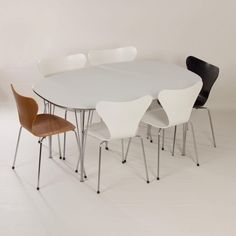 a white table with four chairs around it