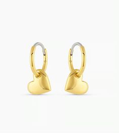 The Lou Heart Huggie Earrings are a beautiful statement piece. Crafted from gold-plated metal, these huggie earrings are the perfect addition to any jewelry collection thanks to their timeless design. 1/2" profile diameter Heart charm measures 5/16" by 3/8" Hinge closure Available in 18k gold plated brass Avoid contact with anything containing derivatives of alcohol Tarnish Resistant Heart Huggie Earrings, Dainty Heart-shaped Tarnish-resistant Huggie Earrings, Heart Charm Huggie Jewelry For Anniversary, Huggie Jewelry With Heart Charm For Anniversary, Gold-tone Pierced Huggie Earrings Gift, Gold-tone Huggie Earrings, Dainty Heart Charm Huggie Earrings For Anniversary, Hypoallergenic Heart Shaped Huggie Earrings, Dainty Tarnish-resistant Huggie Heart Earrings