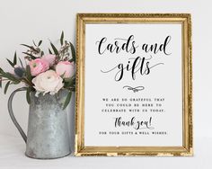 a sign that says cards and gifts next to a vase with pink flowers in it