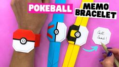 someone is making their own pokeball bracelets out of construction paper and pencils