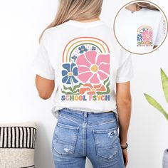 Introducing our vibrant school psychologist crewneck t-shirt, featuring a colorful boho floral and rainbow graphic that is sure to brighten up your day! The design showcases the text "school psych" underneath, making it the perfect addition to your wardrobe. With the unique design printed on both the front pocket and the back, this t-shirt is not only stylish but also comfortable to wear all day long. Show off your passion for school psychology in a fun and fashionable way with this eye-catching School T-shirt With Graphic Print And Relaxed Fit, Relaxed Fit Graphic Print T-shirt For School, Retro Multicolor T-shirt For School, Spring Graphic Print T-shirt For School, Retro Crew Neck T-shirt For Back To School, Multicolor Short Sleeve T-shirt For College, White Retro T-shirt For Back To School, Relaxed Fit Screen Print T-shirt For School, Relaxed Fit Graphic T-shirt For Back To School