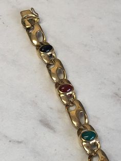 "14kt Yellow Gold Lady's Precious Cabachon Gemstone Bracelet 7\" in Length consisting of 2 Ruby, 2 Sapphire and 1 Emerald 7mm x 5mm Oval Genuine Cabachon Precious Gemstones all bezel set in heavy solid open link chain with a heavy box clasp and a secure fig 8 safety clasp. This flexible and comfortable bracelet weighs 26.1 grams. This item would Retail for $3,559.00" Formal Gold Bracelets With Gemstone Accents, Classic Gold Multi-stone Bracelets, Heart Band, Box Clasp, Wedding Bracelet, Precious Gemstones, Gold Hoop, Mens Wedding Bands, Gold Hoop Earrings