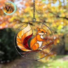 a stained glass squirrel hanging from a chain