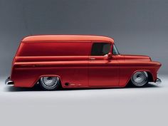 an old red truck with chrome rims