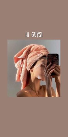 a woman with a towel on her head is taking a selfie