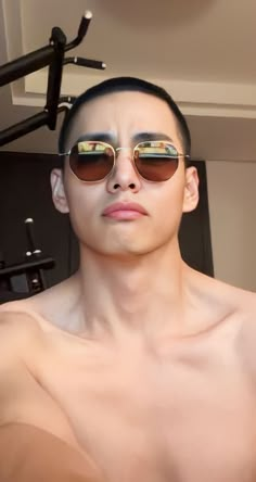 a man with no shirt wearing sun glasses