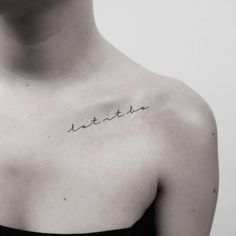 a woman with a small tattoo on her chest that reads, remain until 21 11