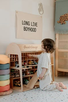 Montessori Toy Shelves 🔆 #MontessoriBed #ChildFurniture #ToddlerRoomDecor #NaturalMaterials #WoodenToys #KidsRoomInspiration #MontessoriHome #EcoFriendlyKids #ToddlerSleep #ParentingIdeas Playroom Car Storage, Car Toys Storage Ideas, Tiny Home Toy Storage, Boy Room With Storage, Toy Cars Organization, Pikler Triangle Storage, Peg Board Toy Storage, Children’s Playroom Idea, Car Themed Playroom